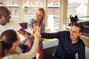 diverse-business-colleagues-high-fiving-together-7PD3CFE
