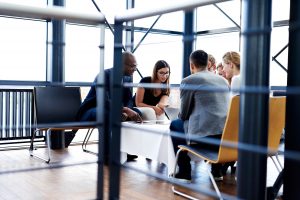 group-of-executives-sitting-together-and-working-PFNDYR7
