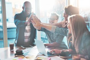 happy-young-entrepreneurs-high-fives-PGCLHP2