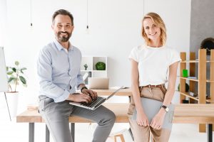 smiling-man-manager-holding-laptop-WQ96J2X